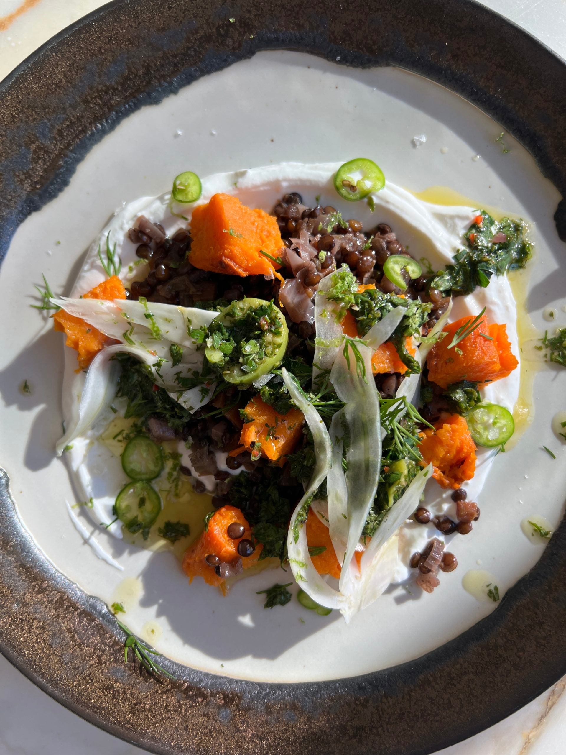 Athena Calderone preparing a meal in a bright, modern kitchen setting.