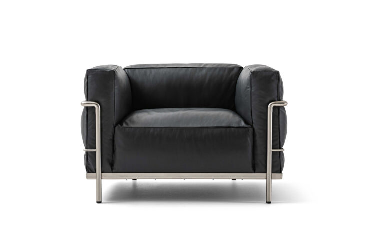 A classic Cassina LC3 Grand Modele Armchair with a polished tubular chrome frame and black leather cushions.