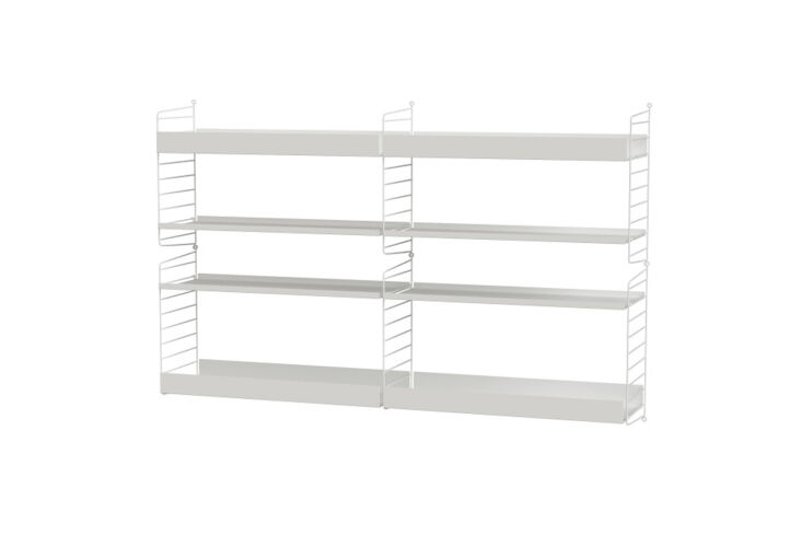 String Furniture modular shelving system in white mounted on a wall.