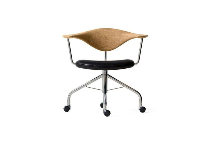 A vintage Hans Wegner Swivel Chair with a wooden frame and black seat.