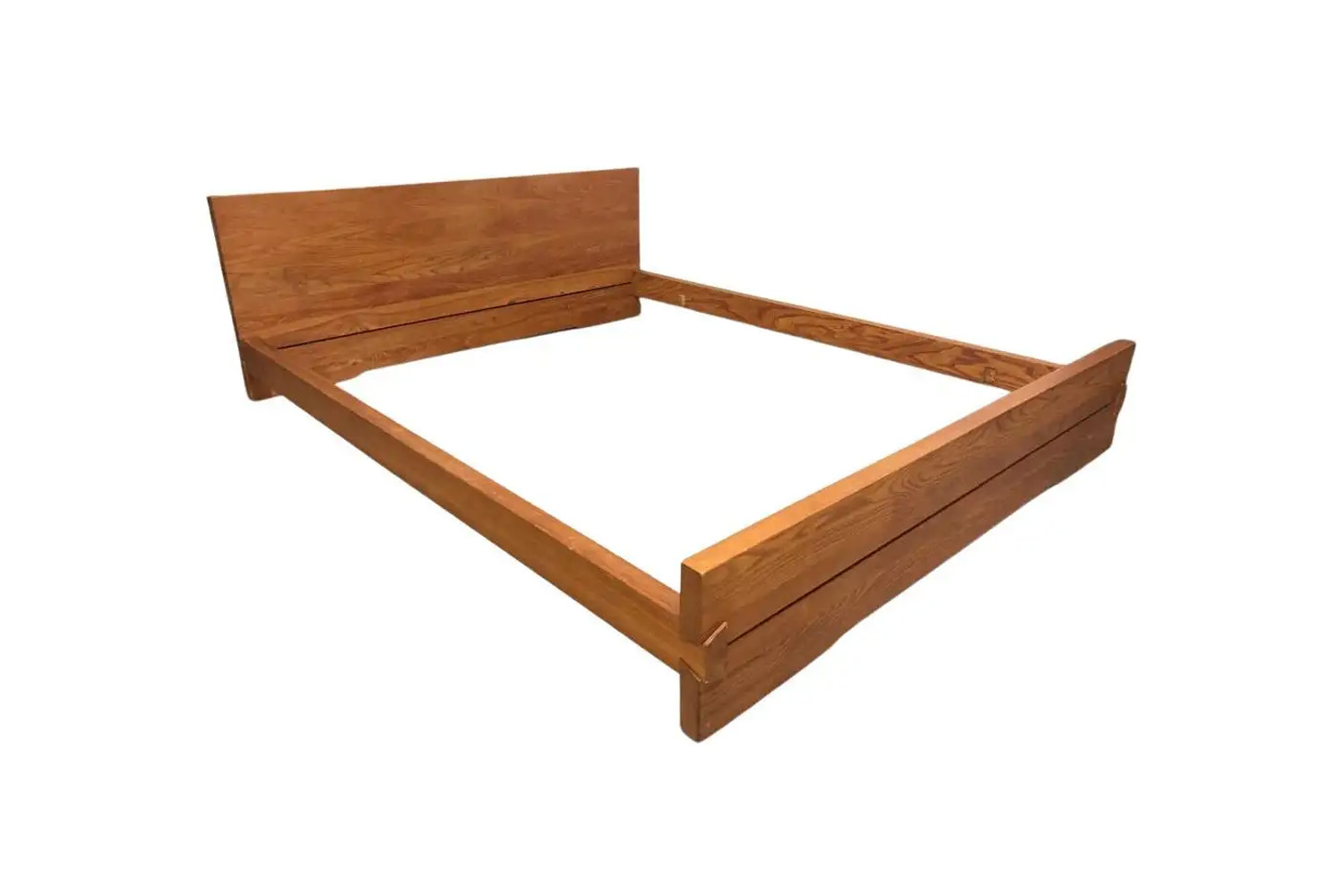 A minimalist solid wood bed frame with visible grain against a clean white background.