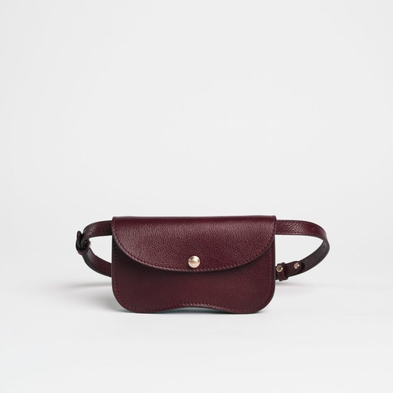 A burgundy-colored faba-shaped leather bag.