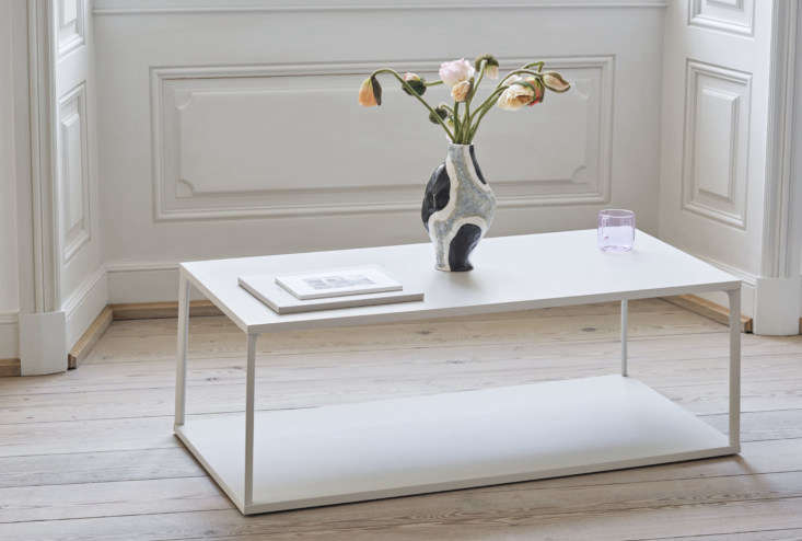 Minimalist white coffee table with a removable tray top design.