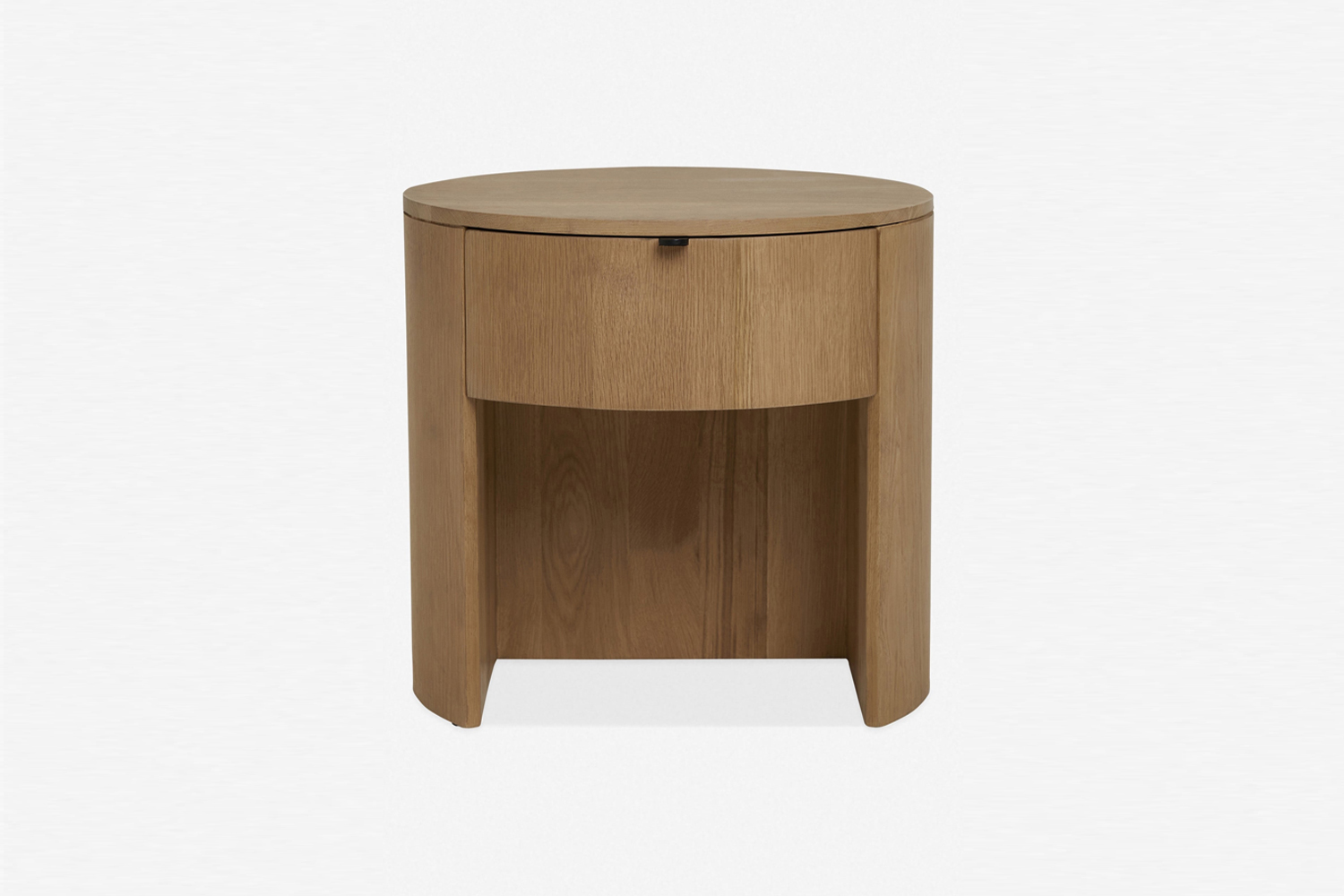 Close-up of a solid oak bedside table featuring a curved design and a single seamless drawer.