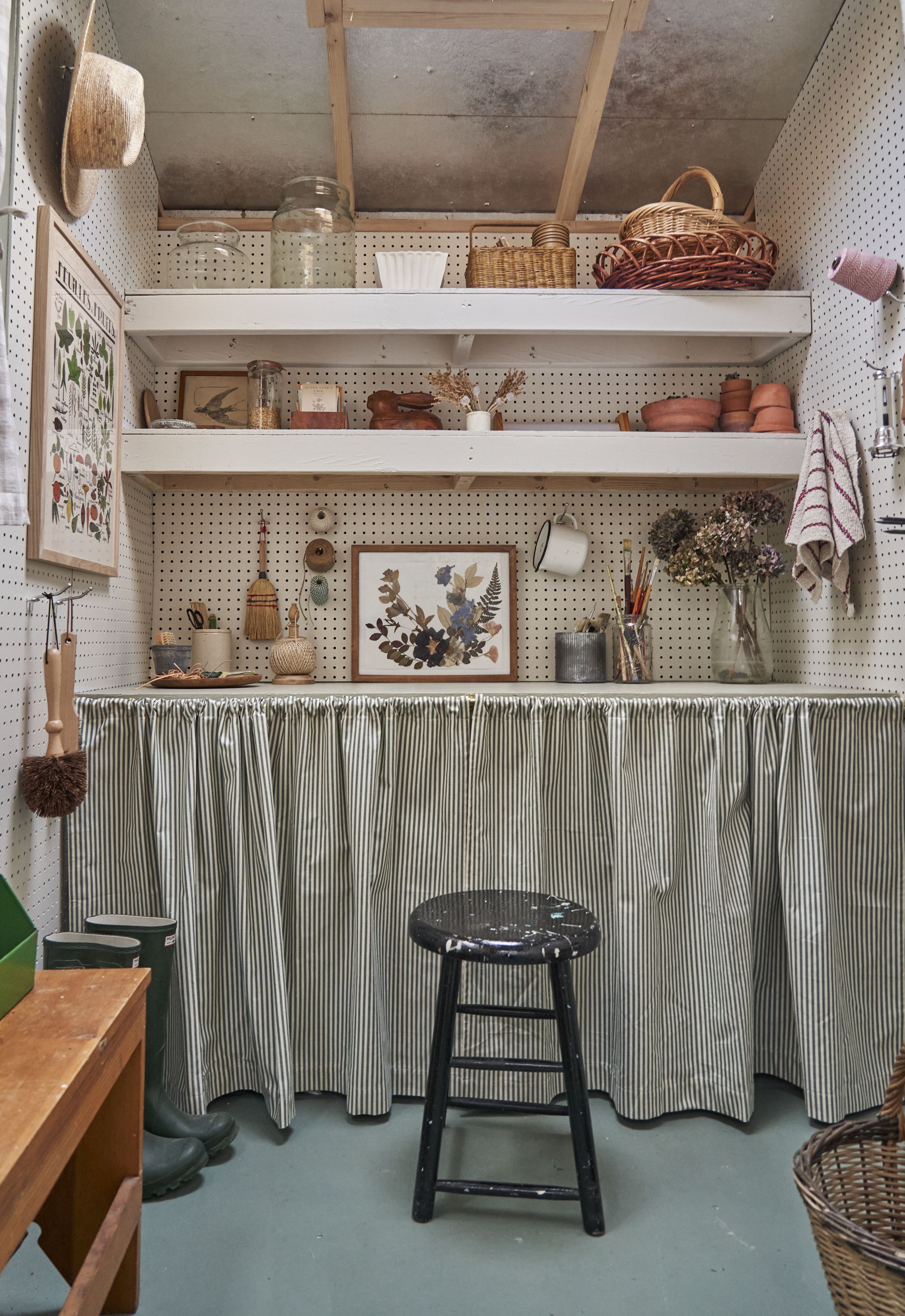 Interior view of a cozy, well-organized garden shed featuring natural wood finishes and personal decor.