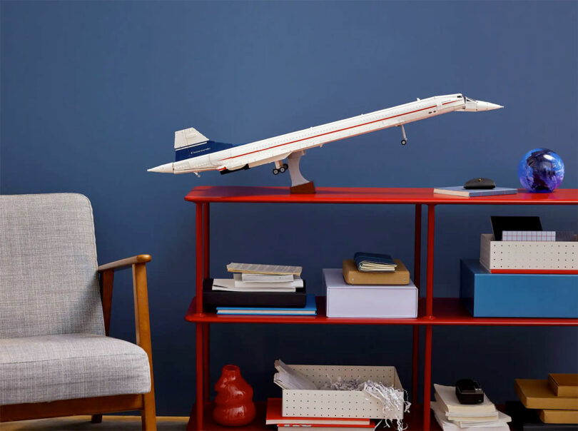 A completed LEGO model of the Concorde displayed on a shelf.