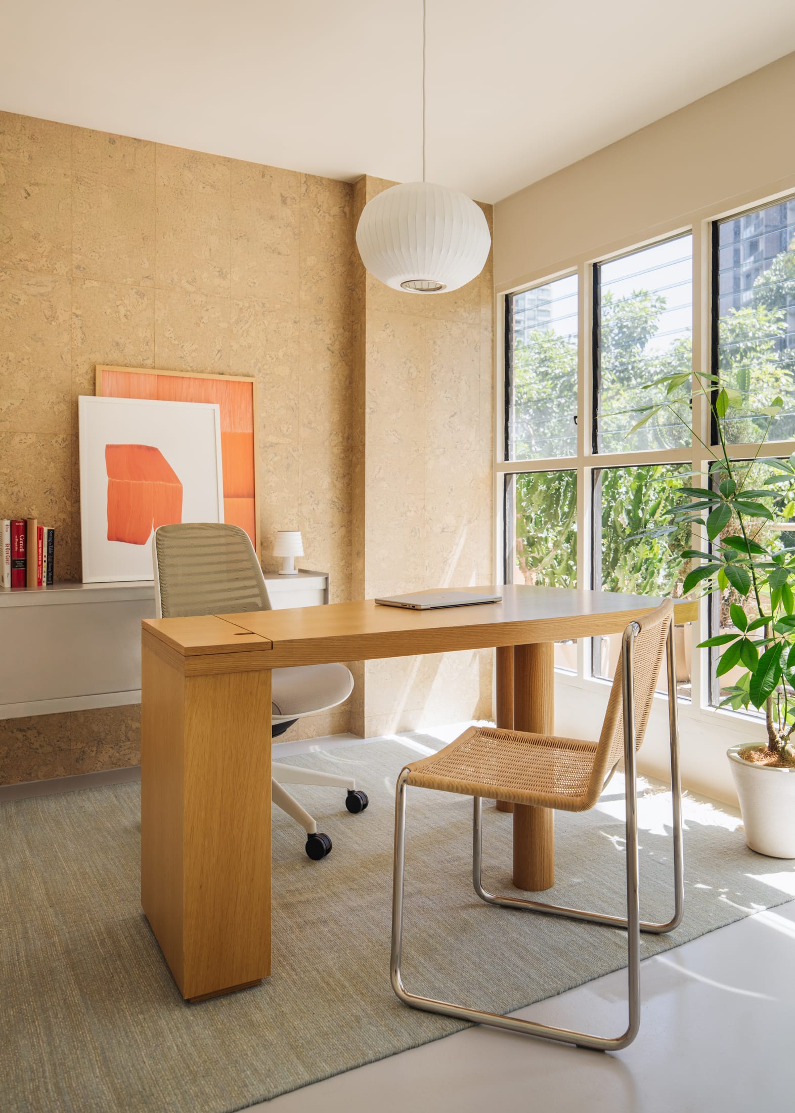 Close-up of a workstation with a green linoleum top and built-in storage integrated into the building's facade.