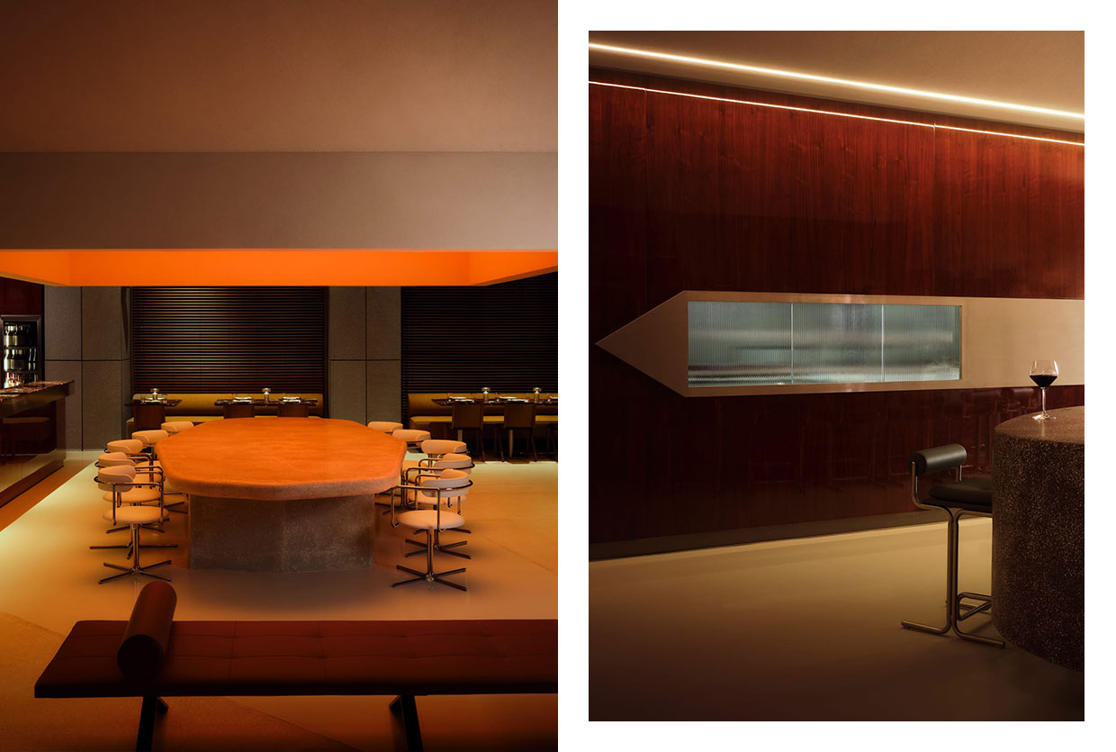 Dramatic low-angle shot of a multi-layered circular ceiling installation emitting warm light over a dining area.