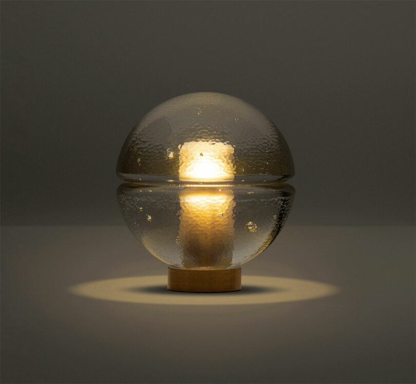 A softly lit spherical glass lamp providing warm ambient light.