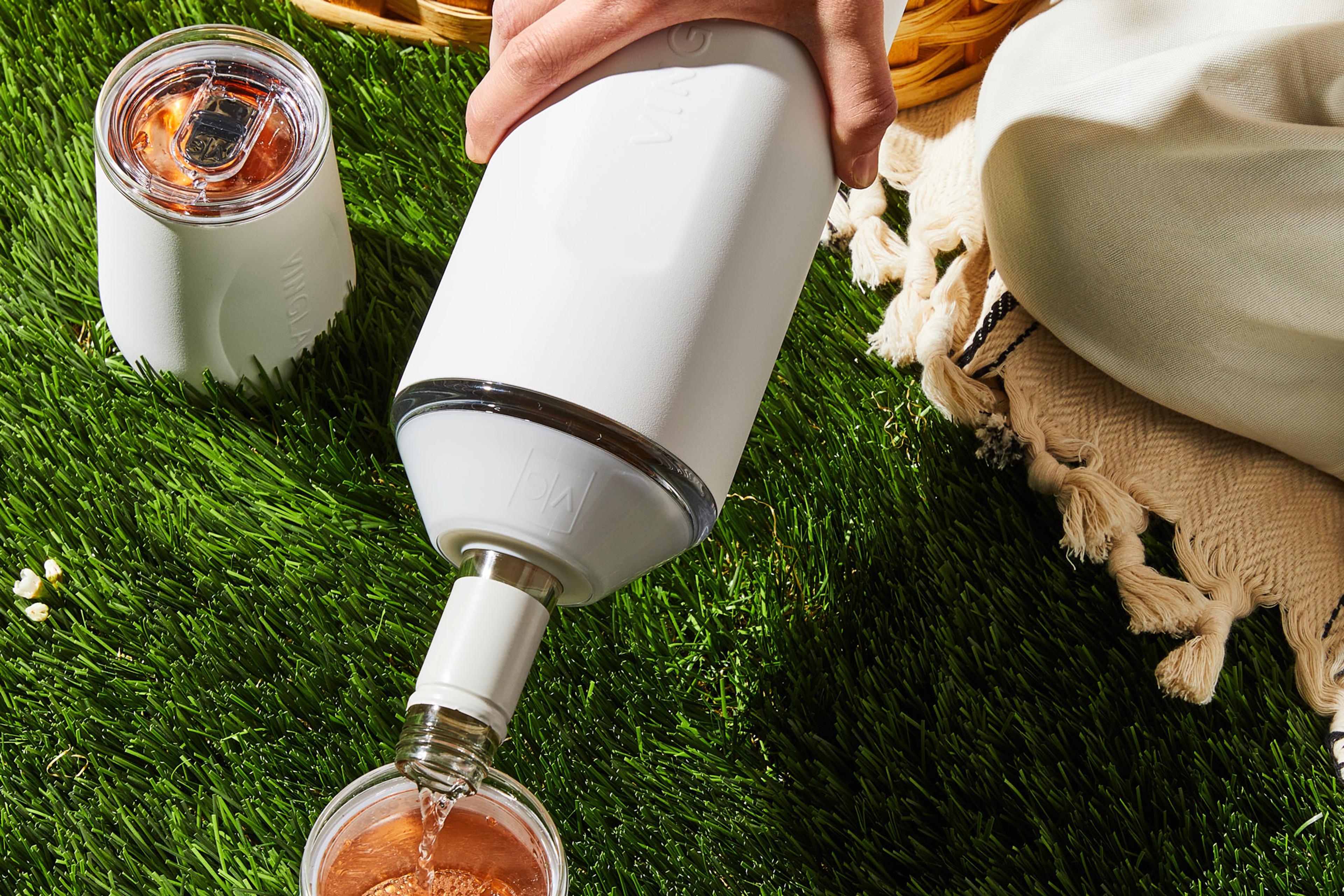 Close-up of a chilled bottle of wine in an insulated setting at an outdoor picnic.