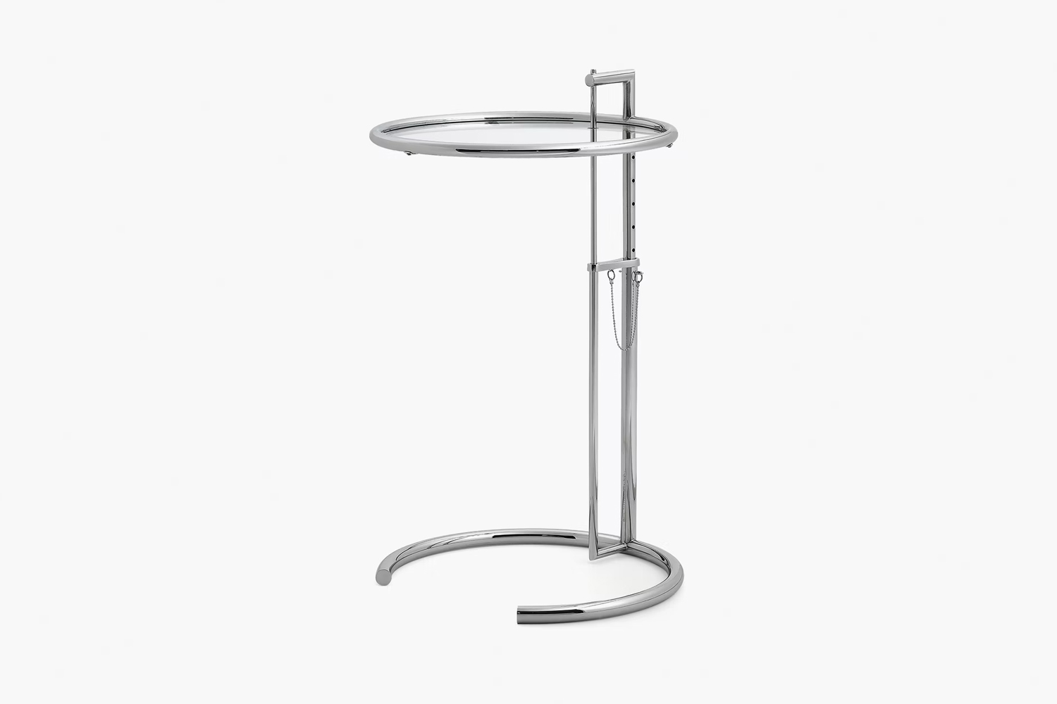 The chrome and glass Eileen Gray E-1027 adjustable table in a modern setting.