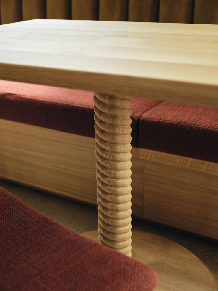 Close-up of a wooden table with twisted oak supports by The Hansen Family.