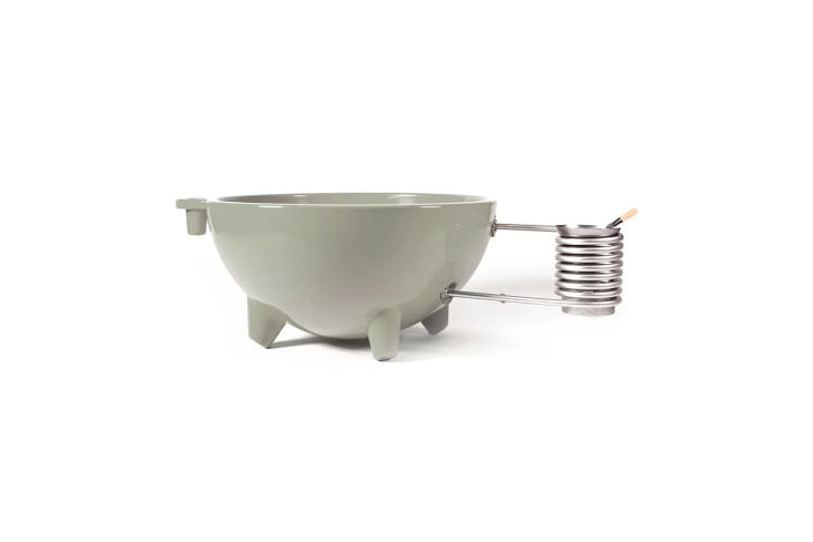 A modern gray ceramic soaking tub with a visible steel heating coil and minimalist lines.