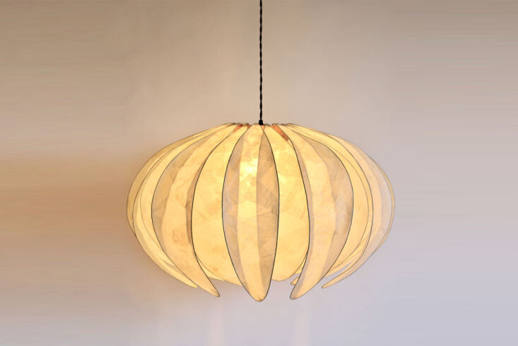 Delicate handmade Peony Pendant lights hanging from the ceiling.