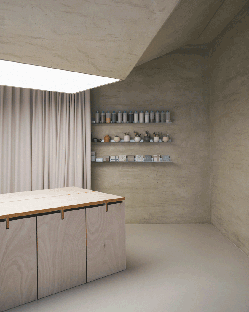 Hidden shelving unit and modeling tools behind minimalist metal blades and curtains.