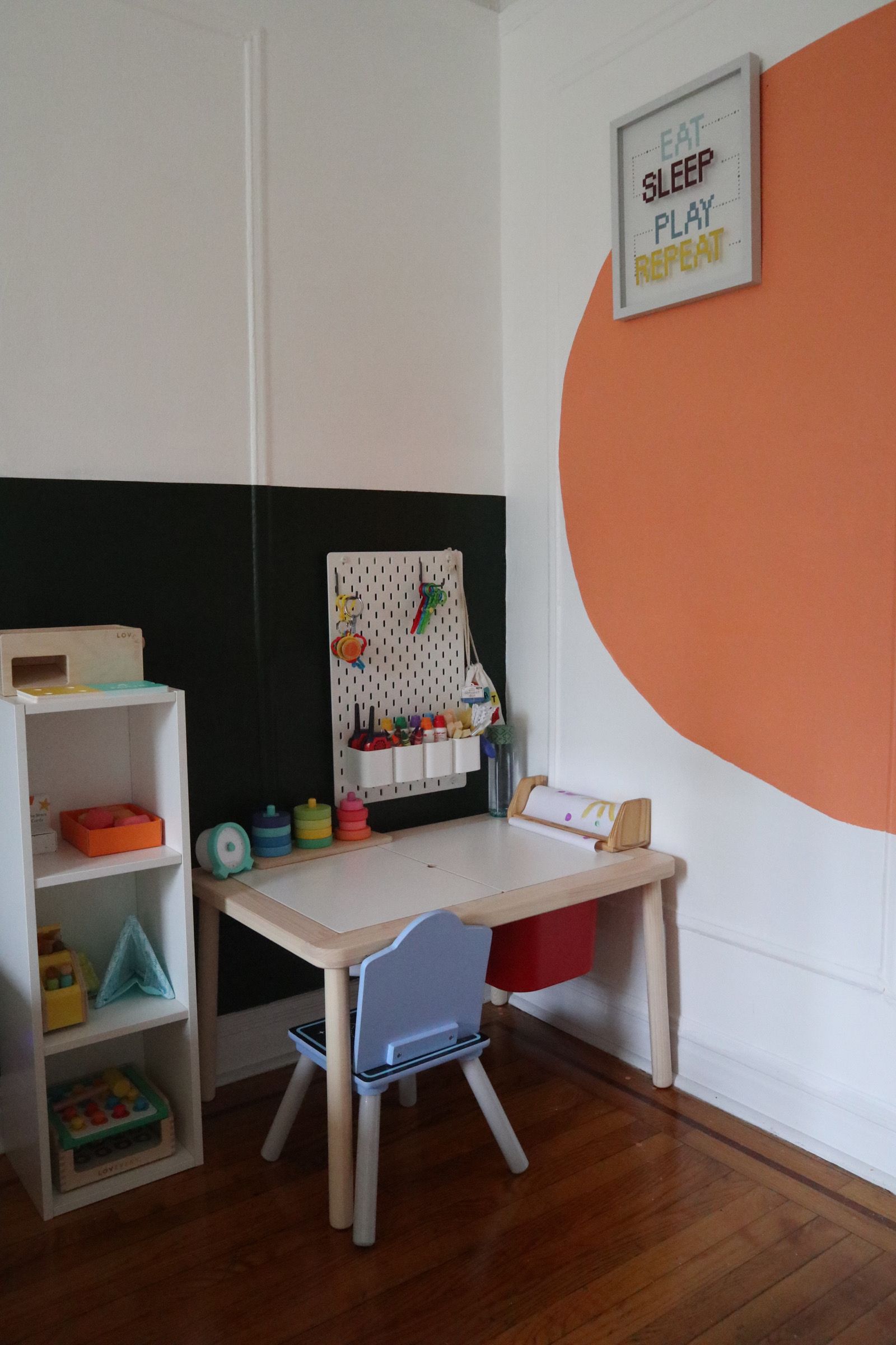 The finished $20 DIY art studio featuring a paper roll and wooden shelf frame.