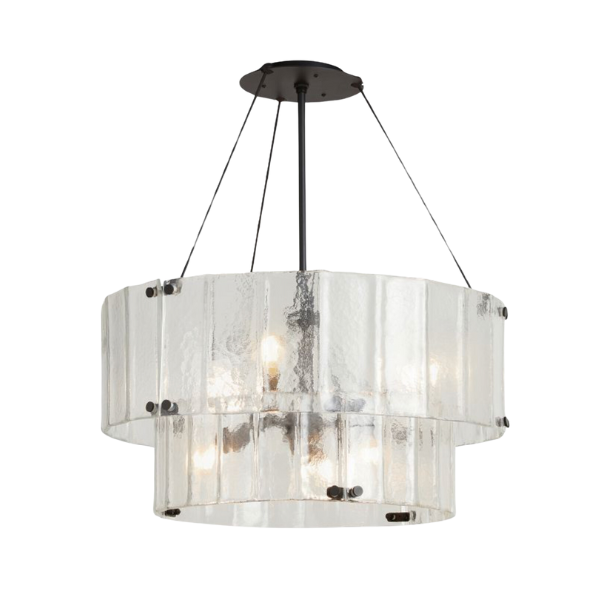 A five-light drum chandelier with a white linen shade providing a soft glow in a dining room.