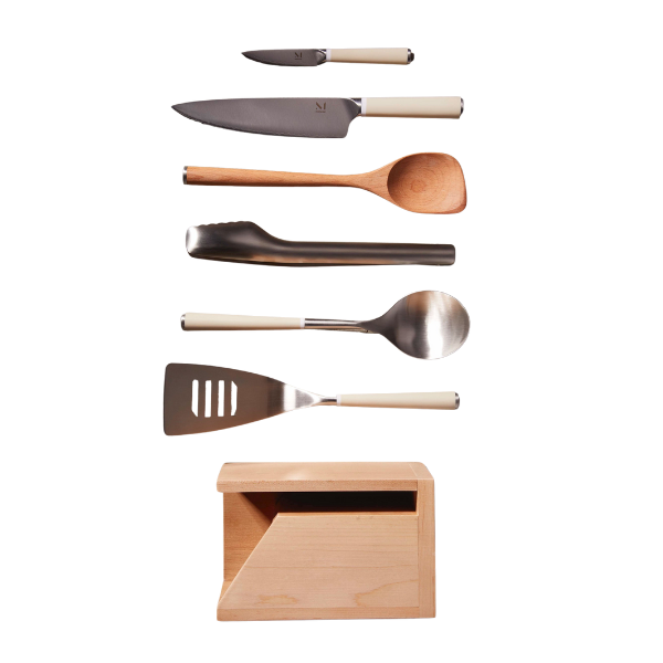 A poached egg being lifted from a pot of simmering water with a slotted spoon.