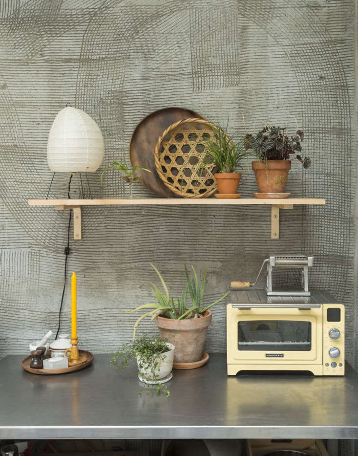 A small Noguchi Akari table lamp on a kitchen counter in an architecture studio.
