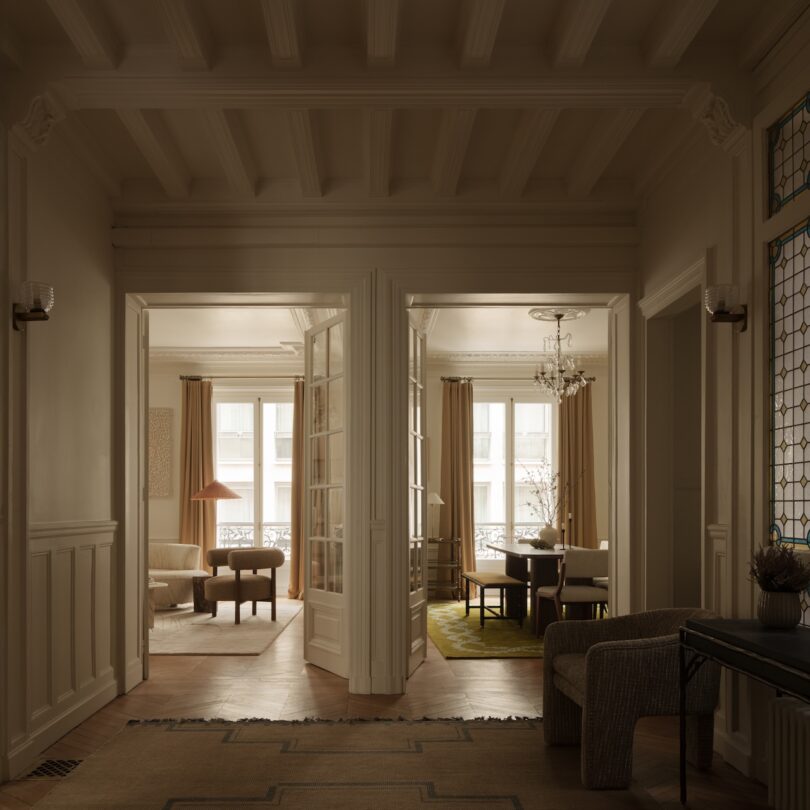 Warmly lit hallway showing wooden floors and the transition between different living spaces in an apartment.