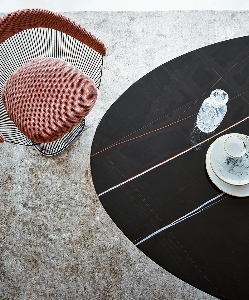 A Piero Lissoni Grasshopper Table with a thin marble top and minimalist metal legs.