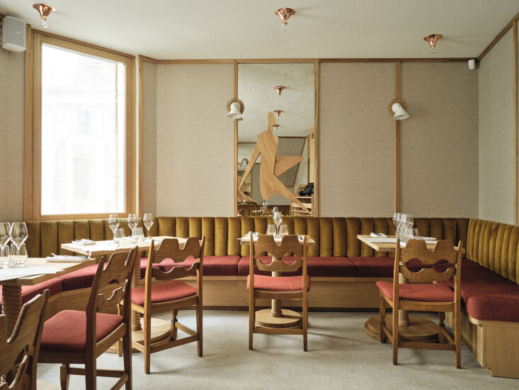 Interior of the back room featuring oak wood wall framing and vintage Razor chairs.