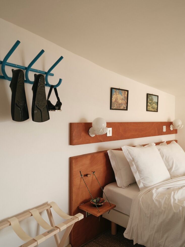 Two nautical fold-down nightstands installed in a guest room.
