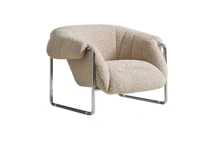 The Orren Ellis Amielia Armchair with cream sherpa upholstery and a thick, chunky chrome frame.