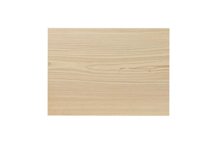 Detailed view of wide-plank Douglas fir wood used for flooring and wall support beams.