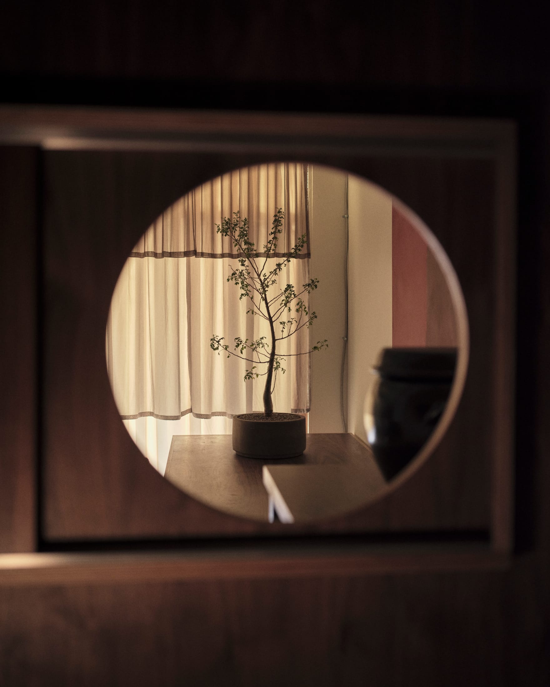 A close-up of a minimalist lounge area with soft seating and a warm, inviting atmosphere.