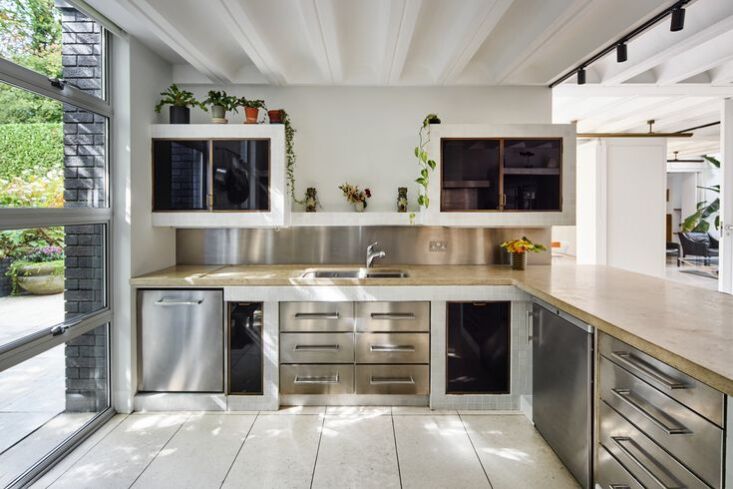 The original glass and bronze cabinetry of the Schreiber House kitchen in London.