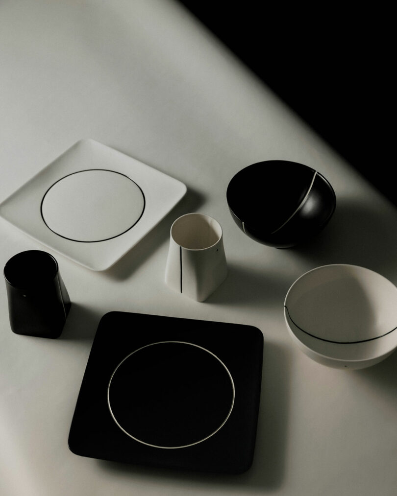 Array of black and white porcelain dinnerware featuring dots and circle patterns.