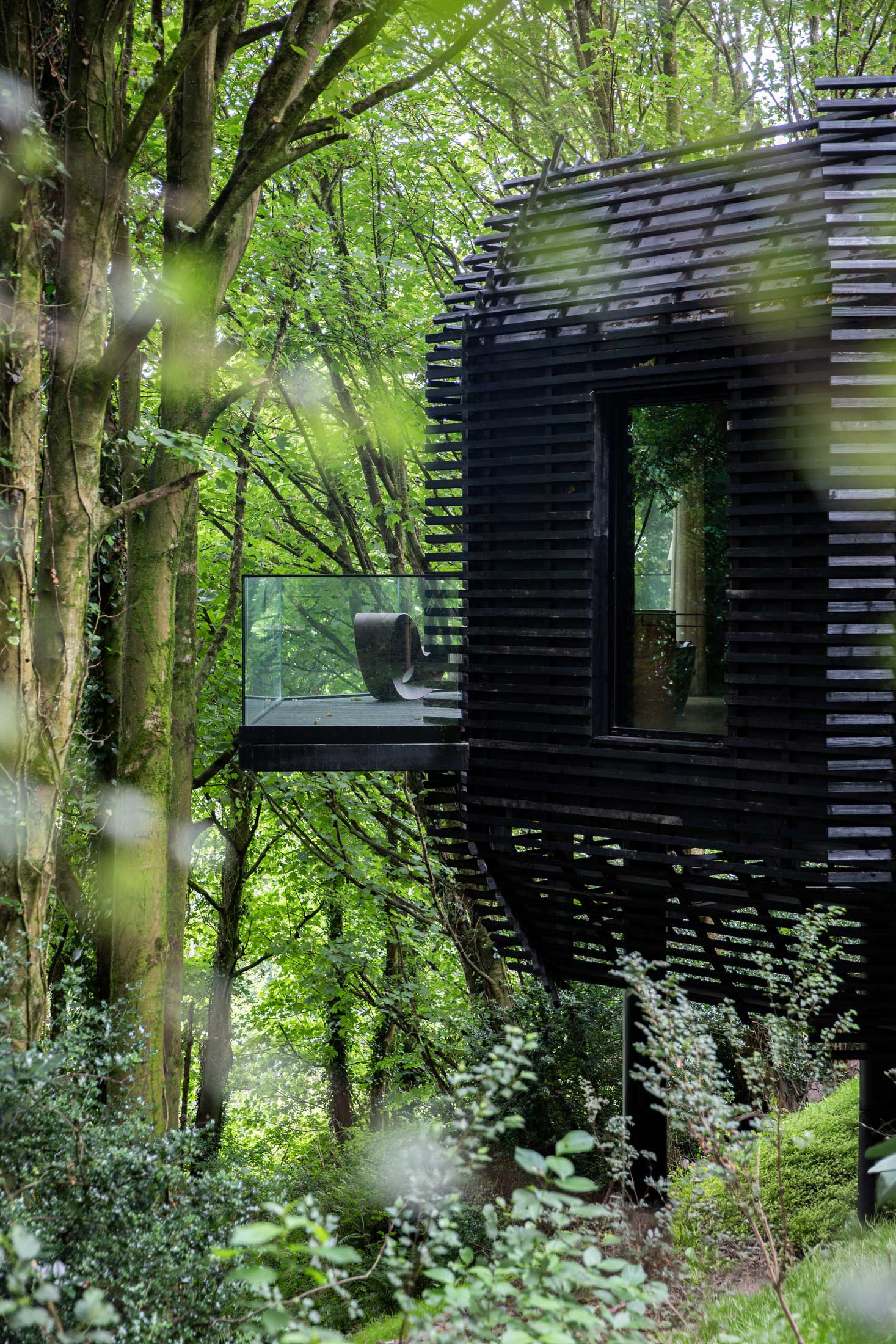 Close-up of the vertical timber cladding and minimalist architectural lines of the suites.