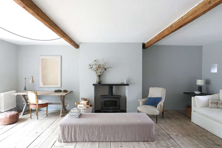 Detail of continuous oak plank flooring running through a door frame without a threshold.