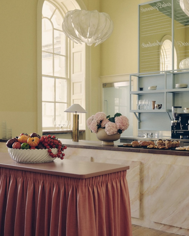 A close-up of a pink faux-painted marble service counter.