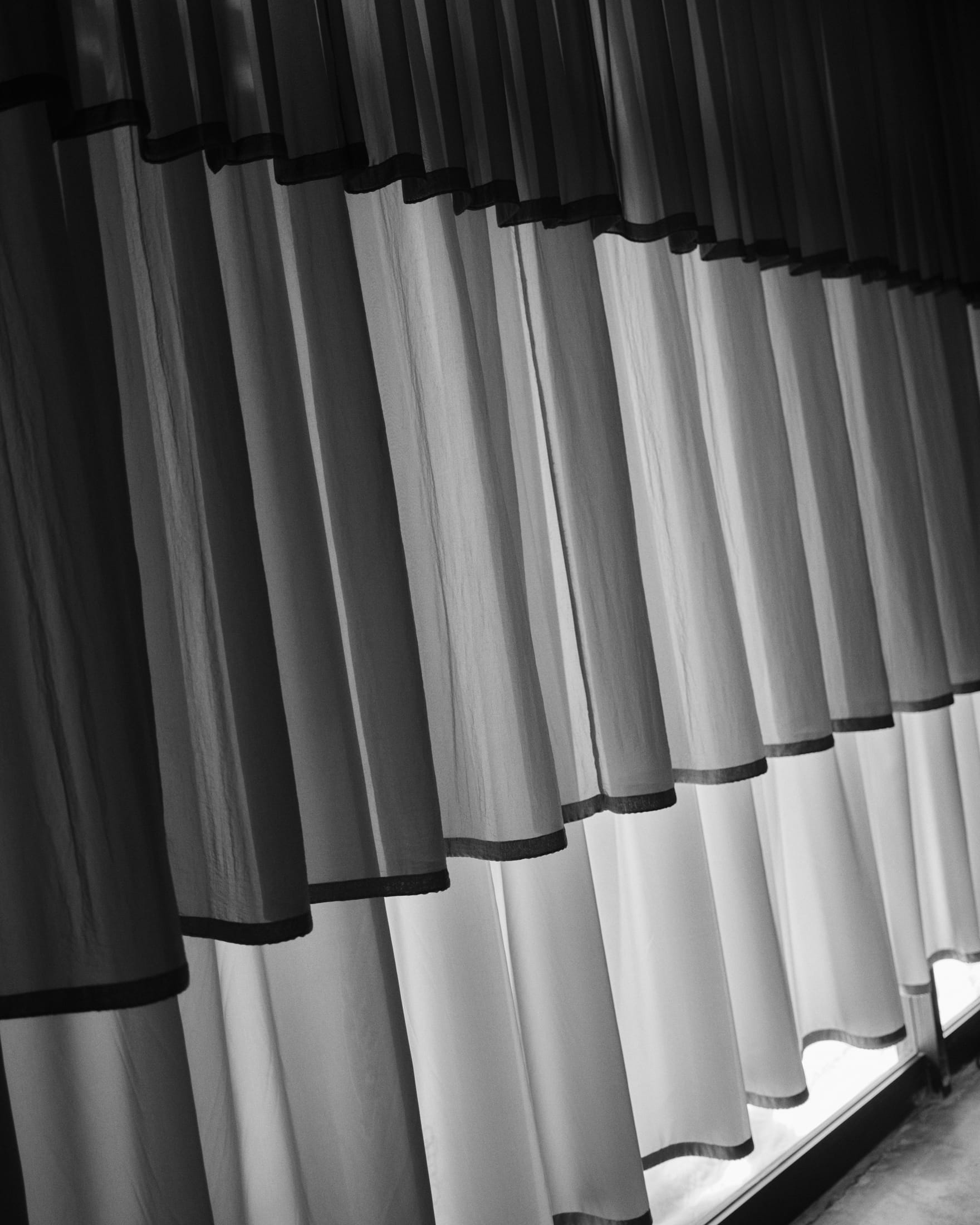 A wide shot of the Aunt Studio designed office space showing the transition between open work areas and curated displays.