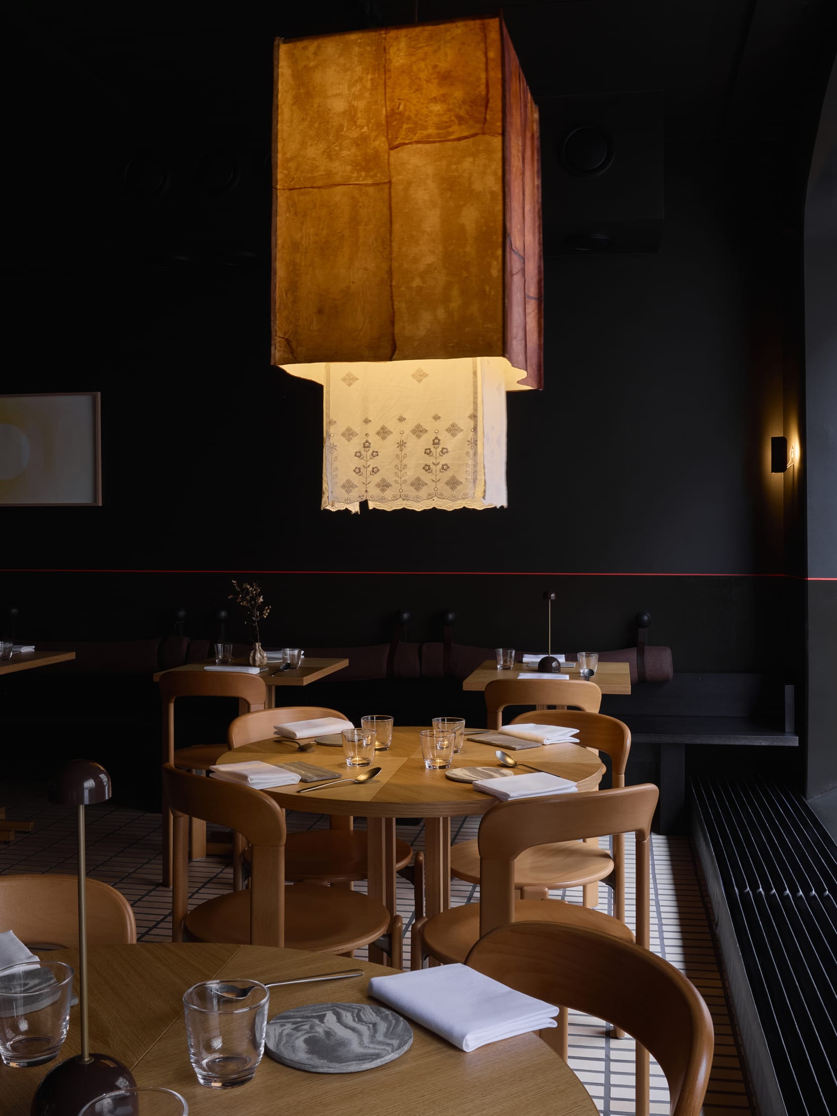 Evening view of the restaurant interior with golden light reflecting off the floor surfaces.