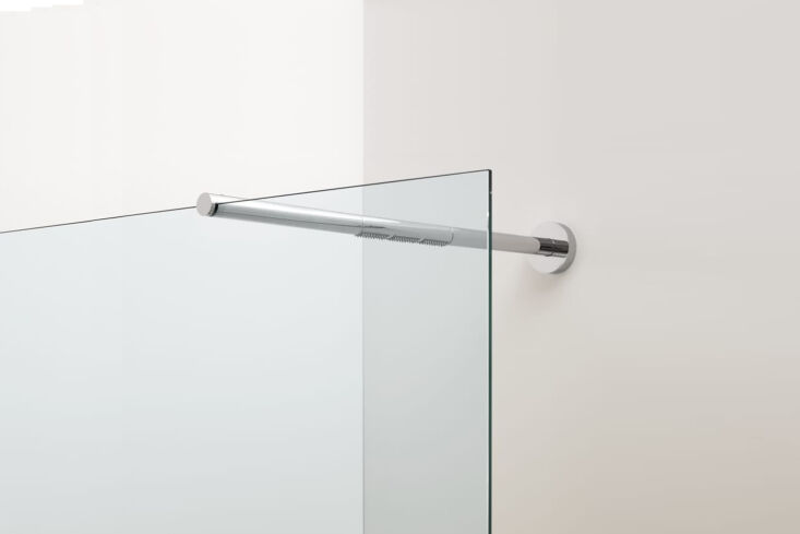 Modern chrome shower bar mounted on a transparent glass panel against a clean white wall.