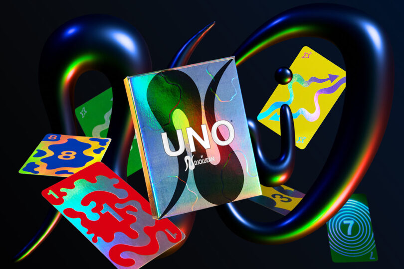 Floating UNO cards with holographic finishes and bold graphic designs against a dark background.