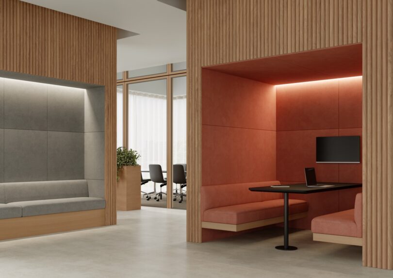 Wide shot of a modern office interior with various seating zones, acoustic booths, and meeting areas.