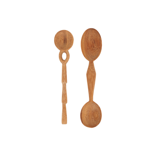 Minimalist brass measuring spoons and a professional chef's knife on a marble surface.
