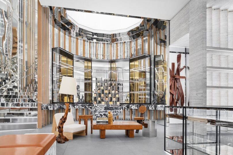 Modern interior featuring geometric mirrored shelving, a central bar, and sophisticated vertical architectural lines.