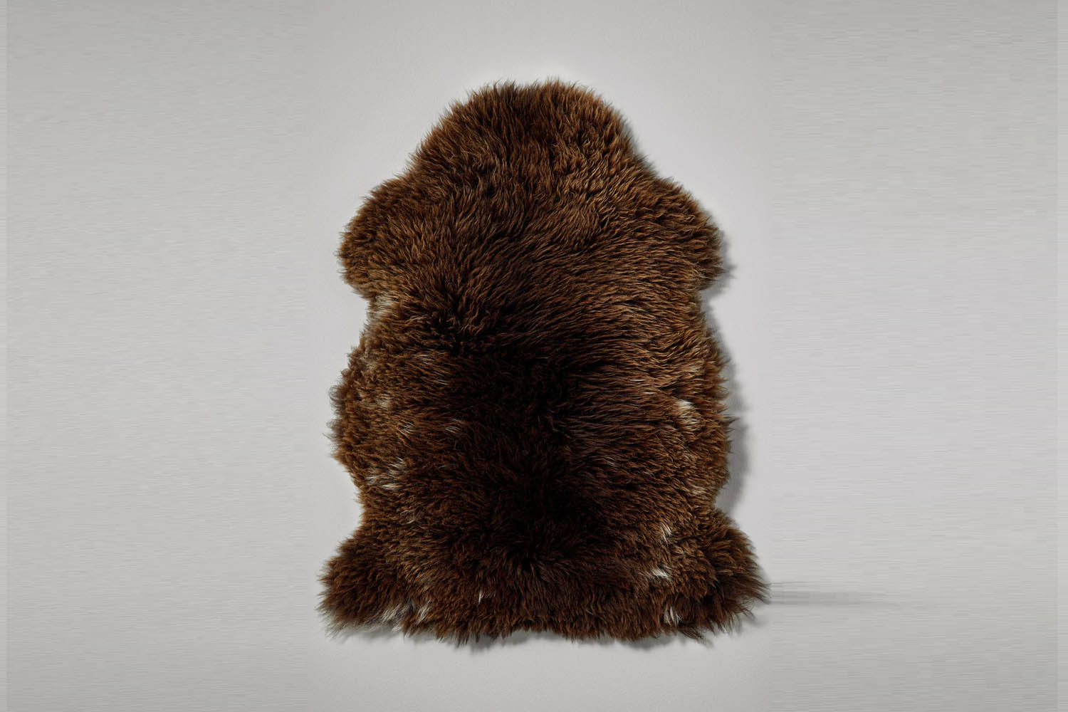 A dark brown Welsh Mountain sheepskin rug.