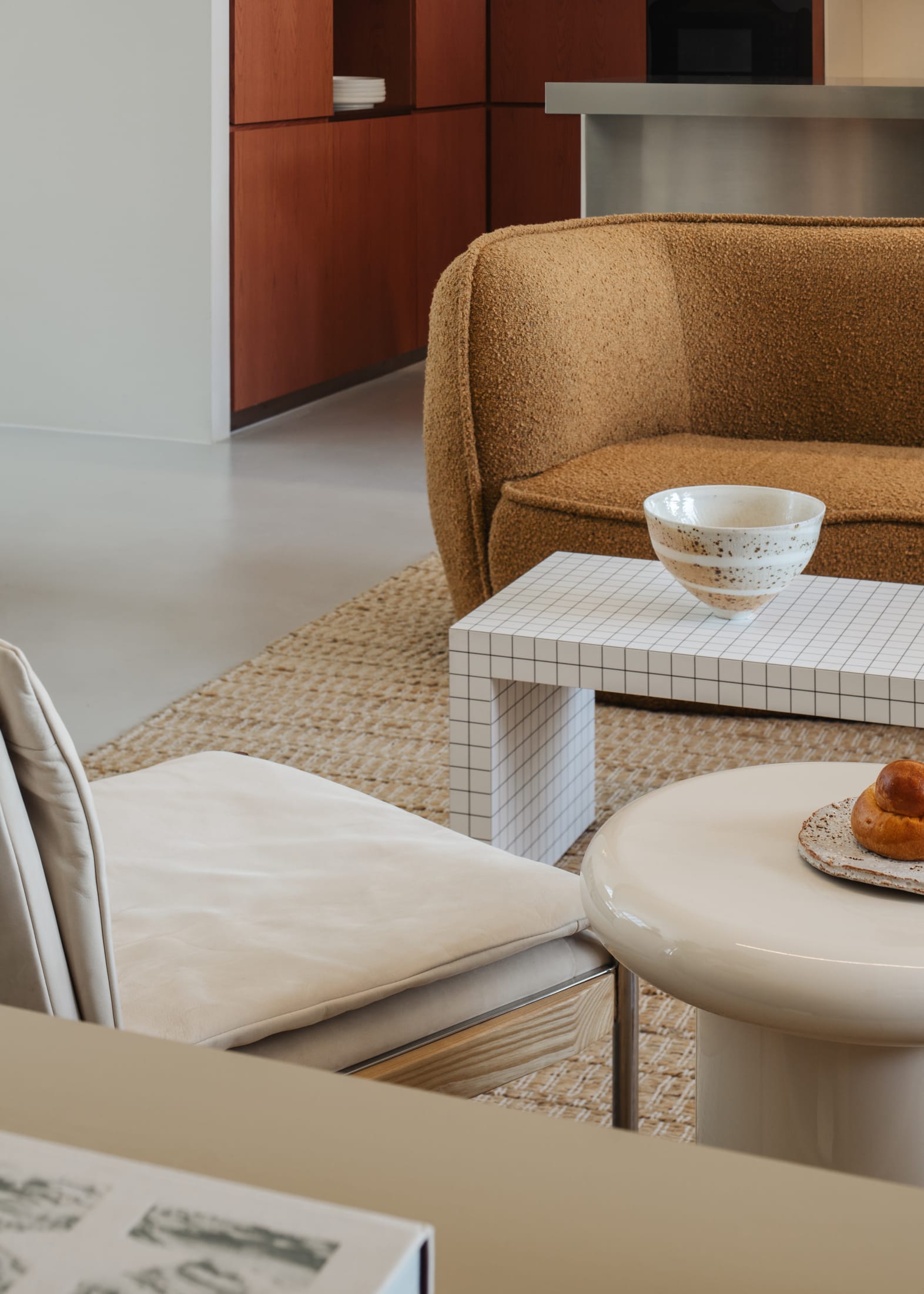 The double-height communal kitchen area with a large central table and red accents.