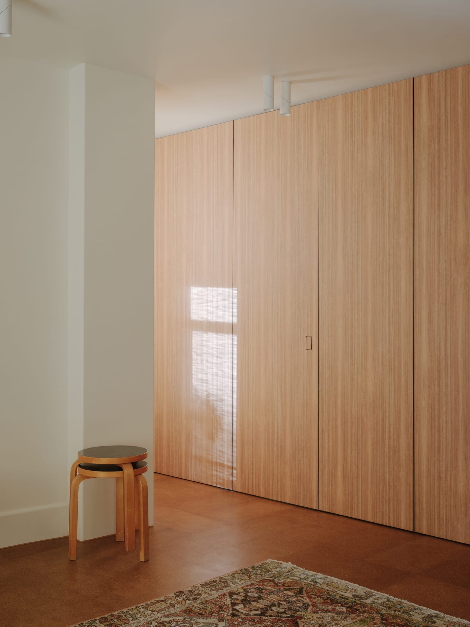 Living area of the Caringal Flats apartment with natural light and modernist layout.