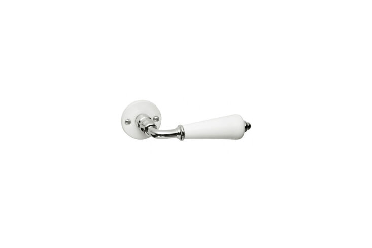 A white porcelain double door handle, showing the detail required in professional heritage restoration.