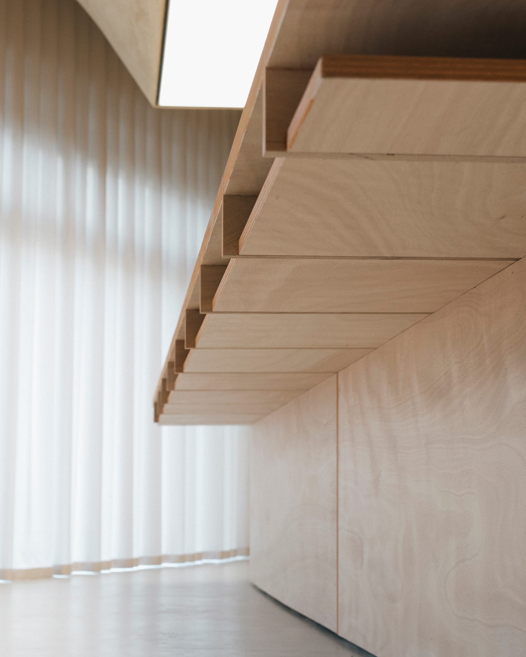 Detail shot of the textured rammed-earth wall finish made from recycled brick waste.