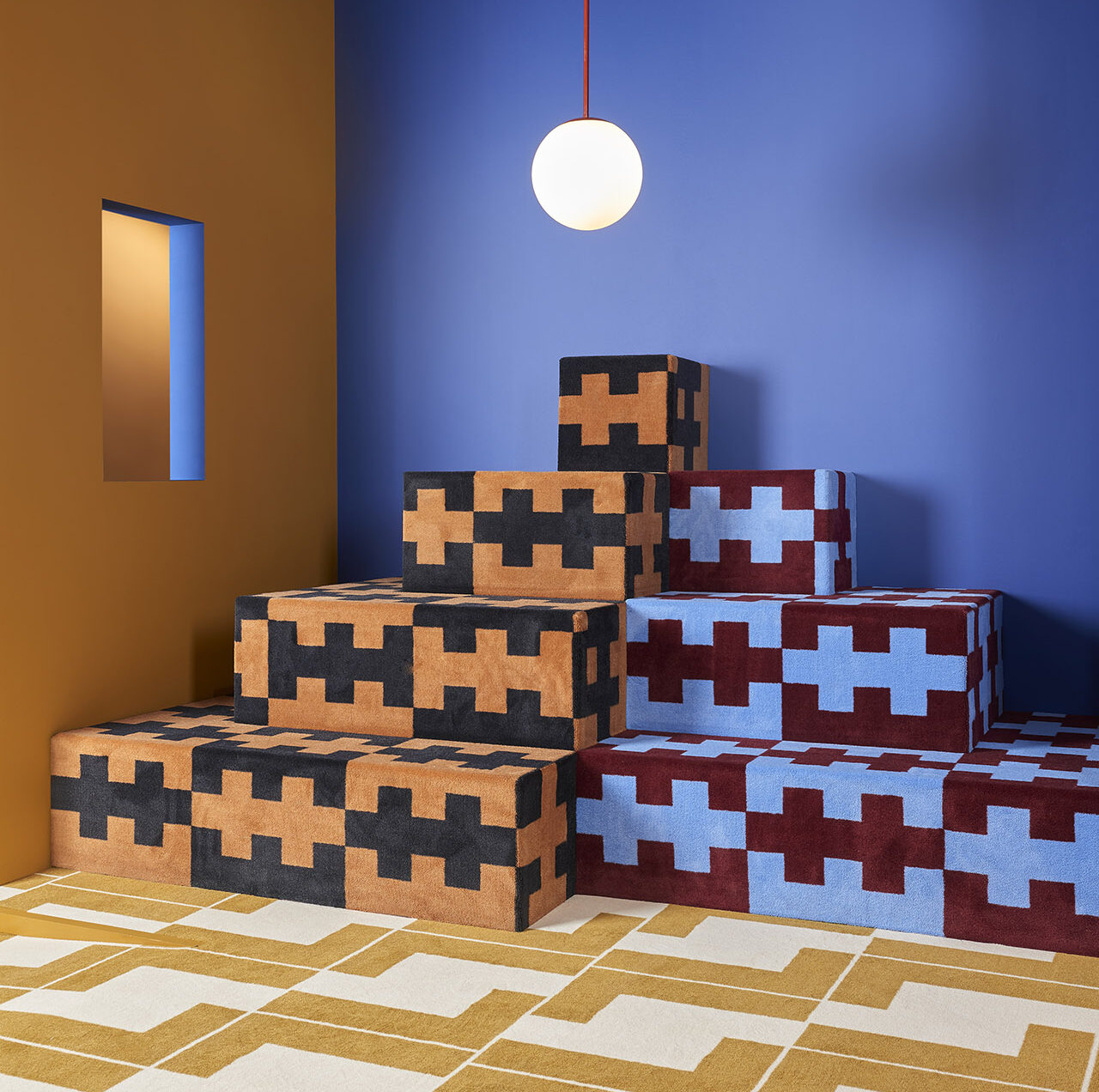 Modern living room with blue and mustard walls and geometric cube seating.