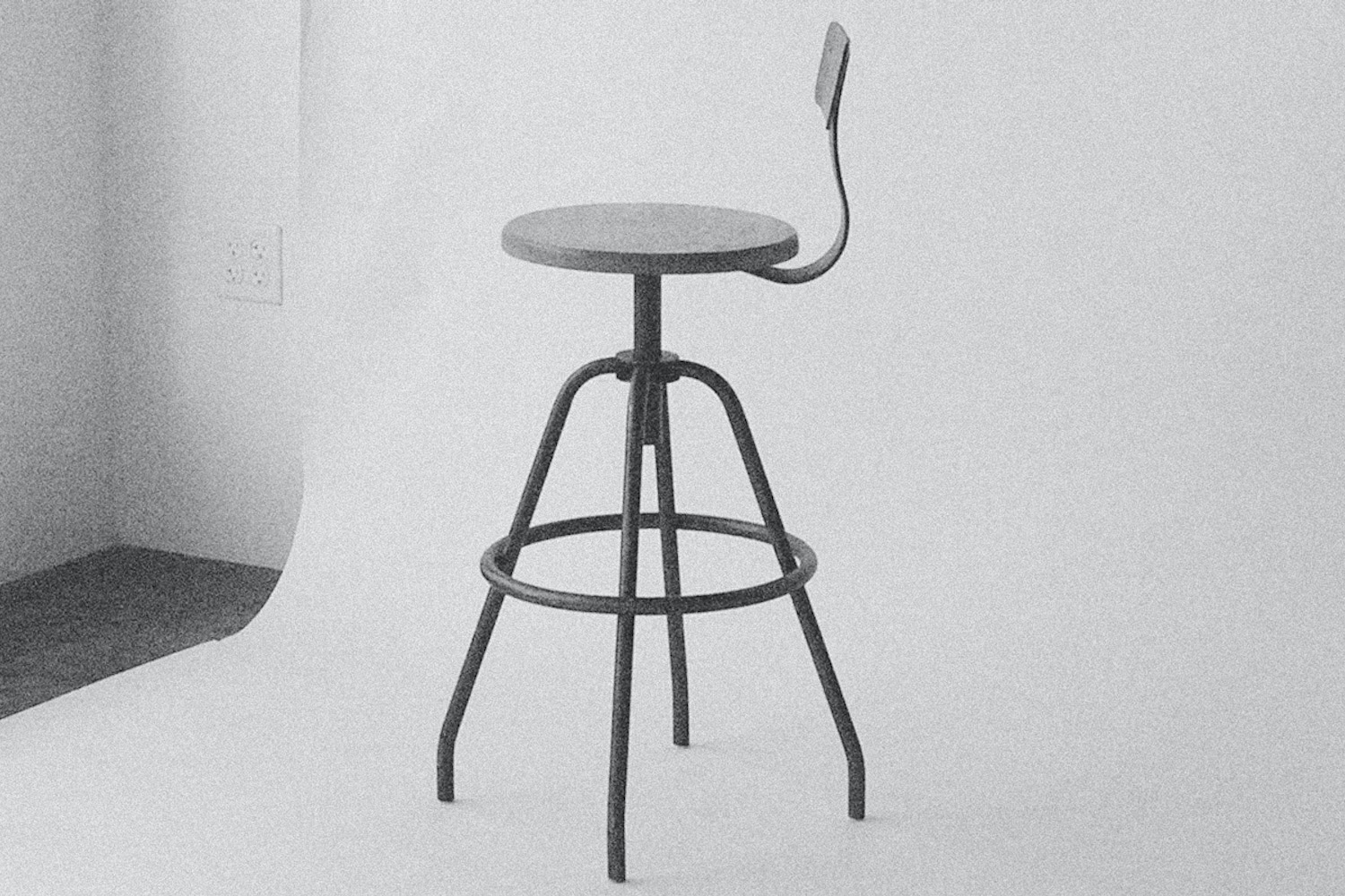 A curated selection of industrial bar stools with backrests in various finishes.