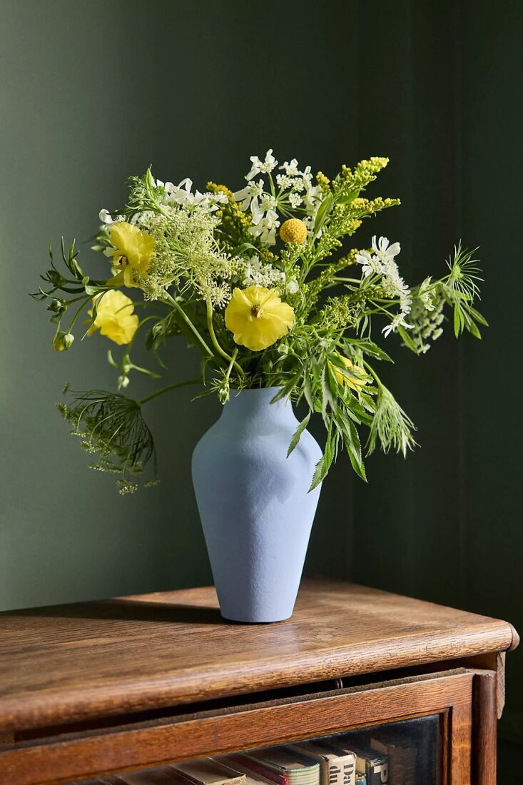 An organic blue ceramic vase acting as a decorative accent.